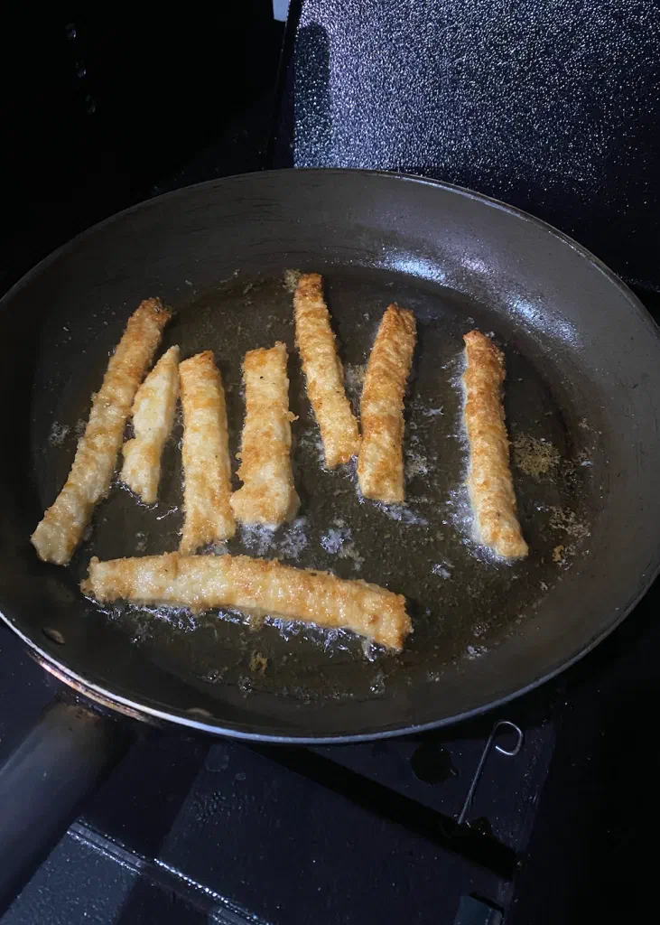 Low carb fries frying golden in a pan
